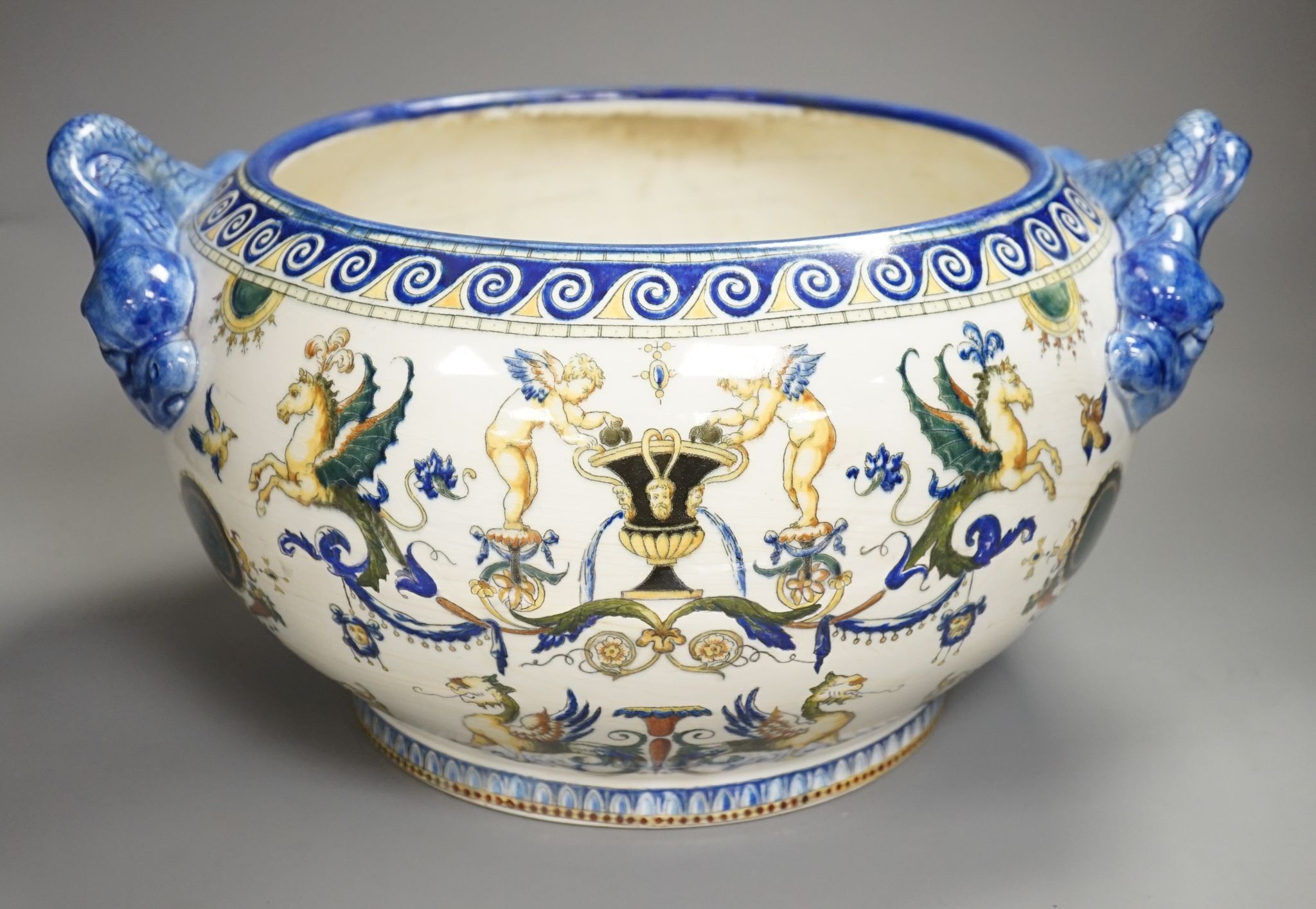 A French 19th century Gien pottery jardiniere with dolphin handles, 41 cms wide including handles.